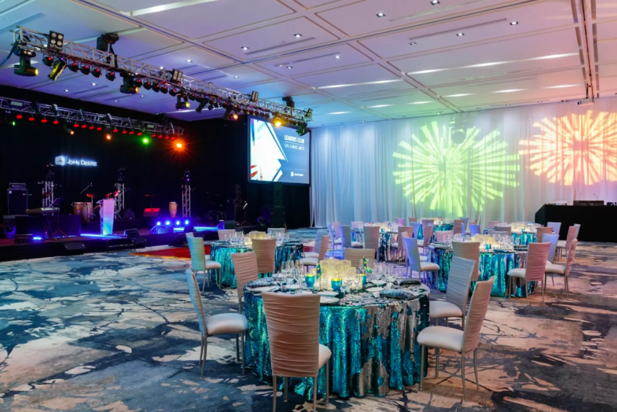 Grand Velas ballroom reception with blue sequin linens and light projections at Grand Velas Los Cabos