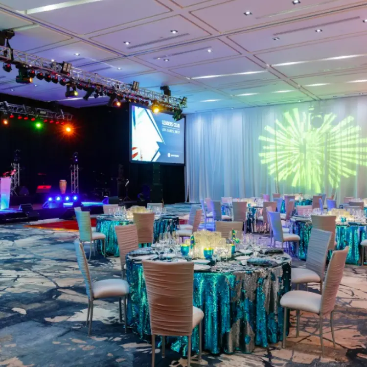 Grand Velas ballroom reception with blue sequin linens and light projections at Grand Velas Los Cabos