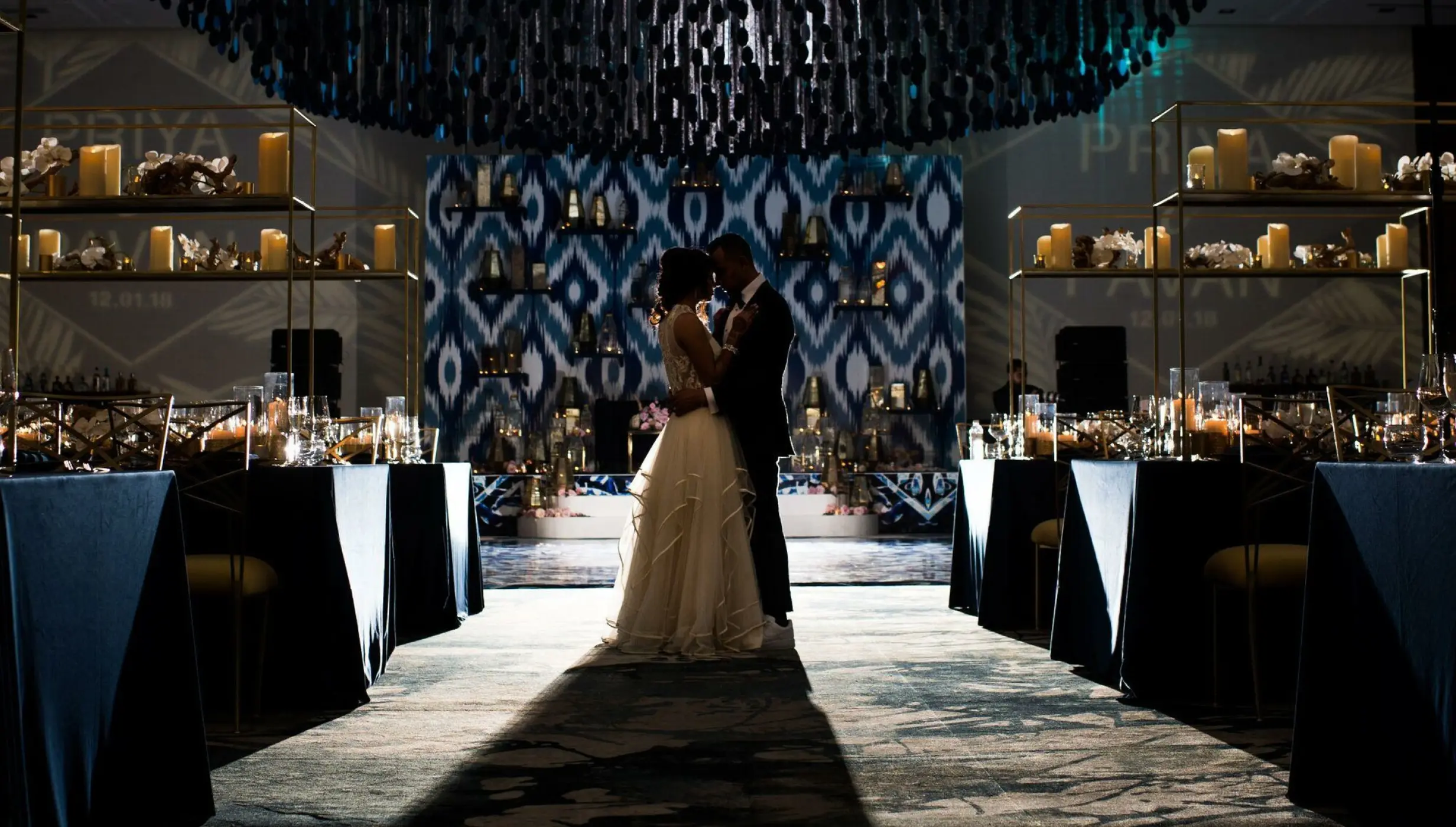 Couple embracing at heir wedding in the Grand Velas Los Cabos Resort ballroom