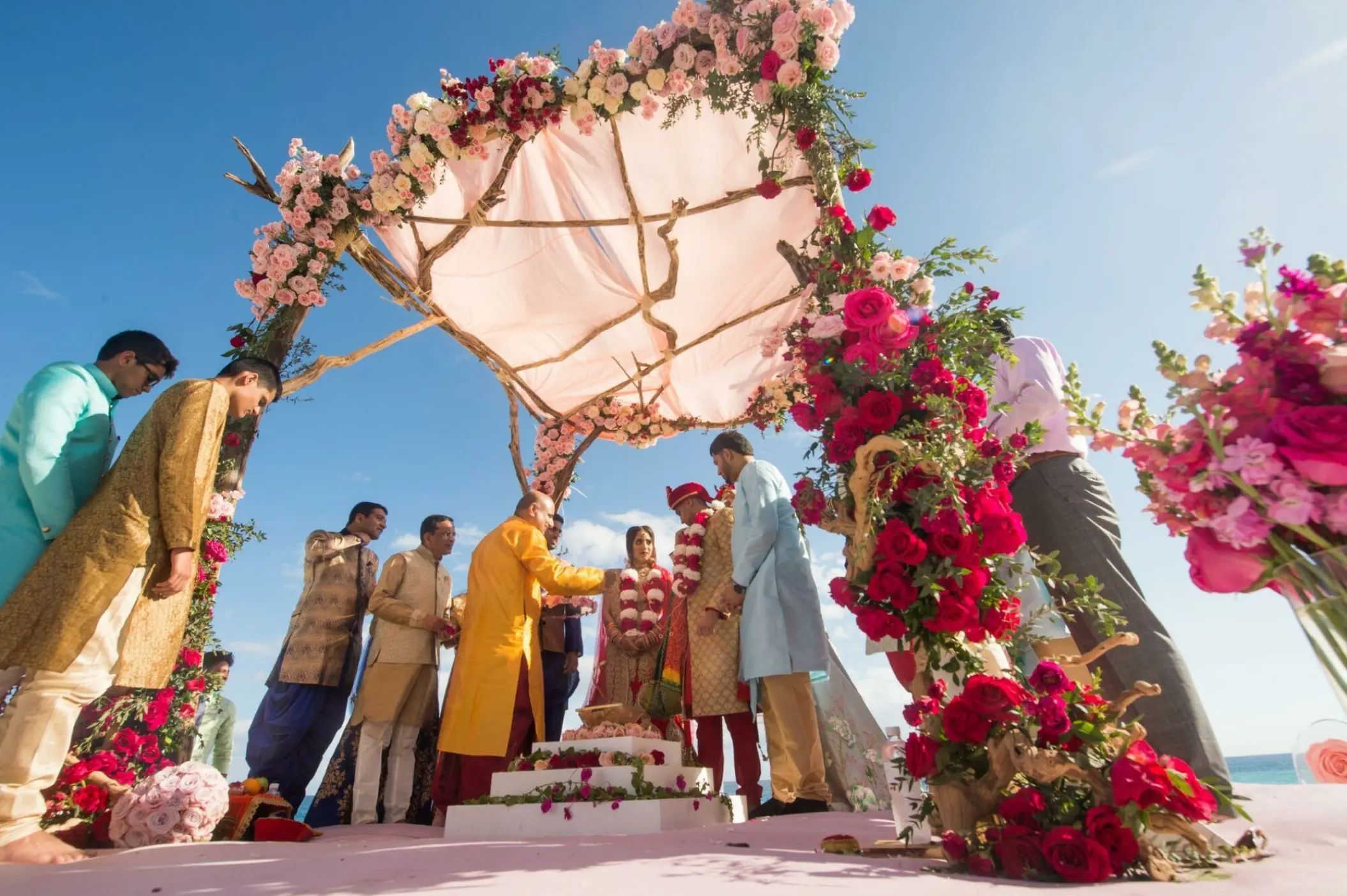 Indian wedding ceremony under a floral mandap at Grand Velas Los Cabos, Cabo San Lucas