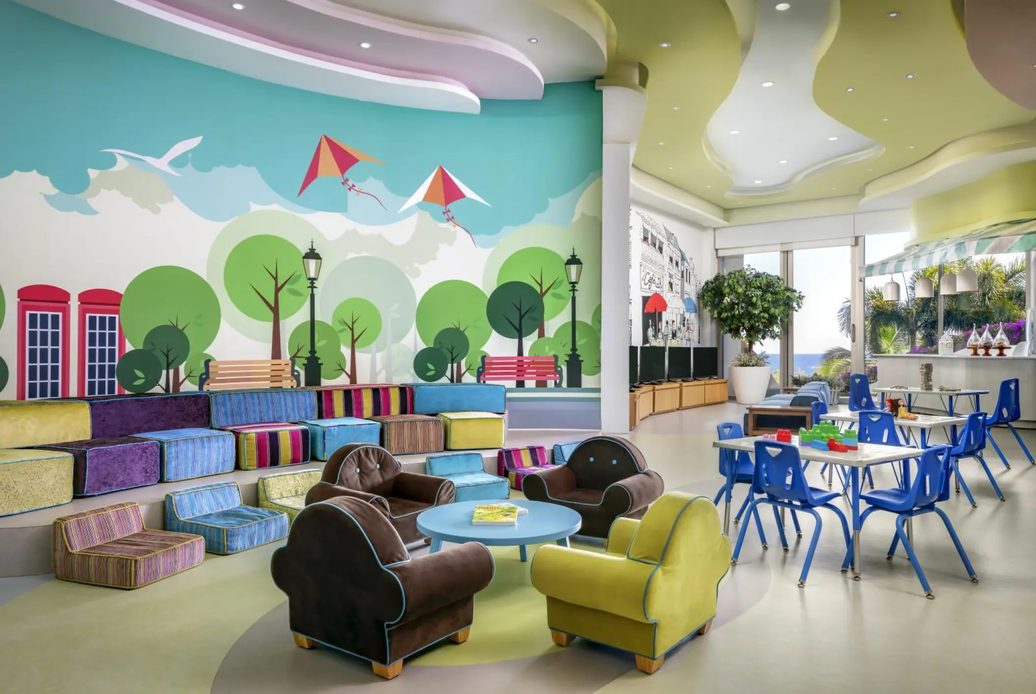 Colorful kids club with mural walls and child-sized seating at Grand Velas Los Cabos, Cabo San Lucas