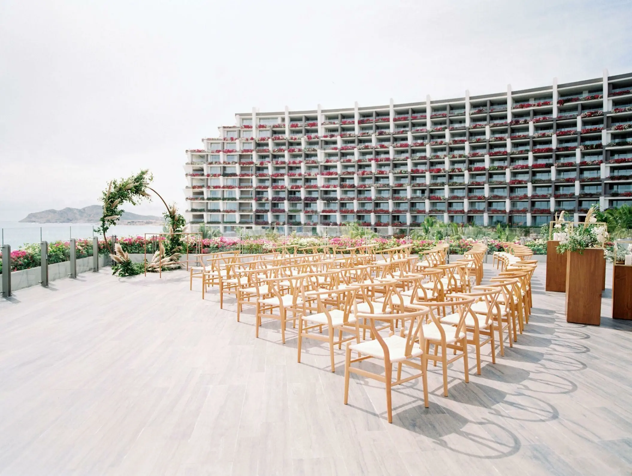 Terraza del Mar wedding ceremony setup with wooden chairs at Grand Velas Los Cabos, Cabo San Lucas