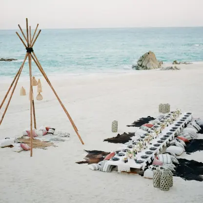 Boho beach reception with floor seating and teepee decor at Grand Velas Los Cabos, Cabo San Lucas