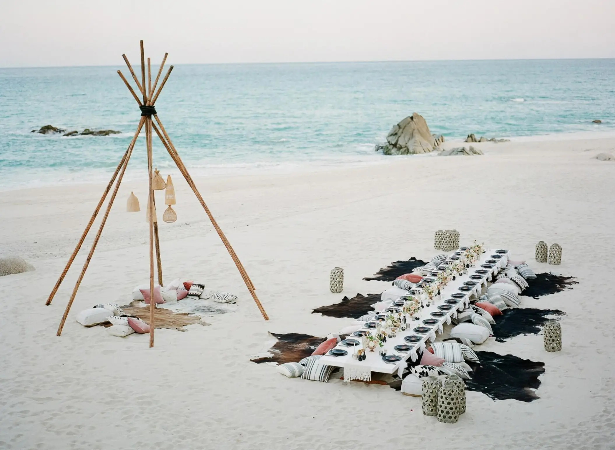 Boho beach reception with floor seating and teepee decor at Grand Velas Los Cabos, Cabo San Lucas