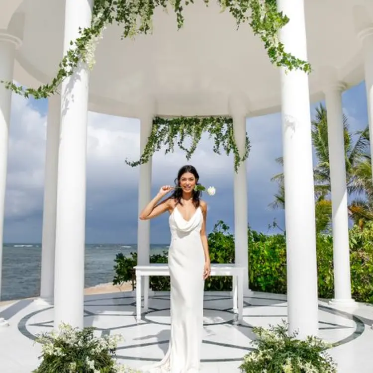 Bride standing under a white gazebo for a wedding ceremony at Grand Palladium White Sand, Riviera Maya