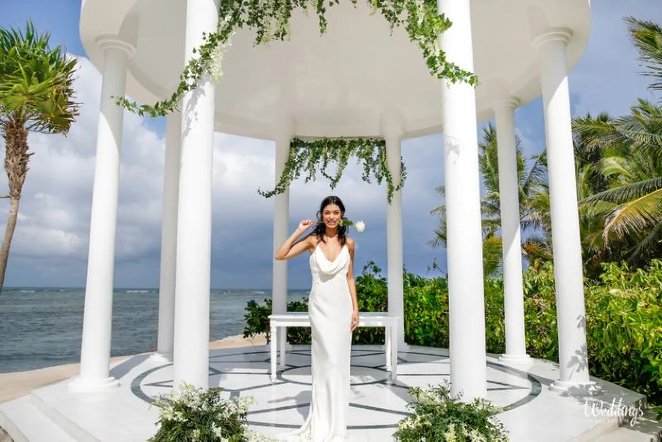 Bride standing under a white gazebo for a wedding ceremony at Grand Palladium White Sand, Riviera Maya