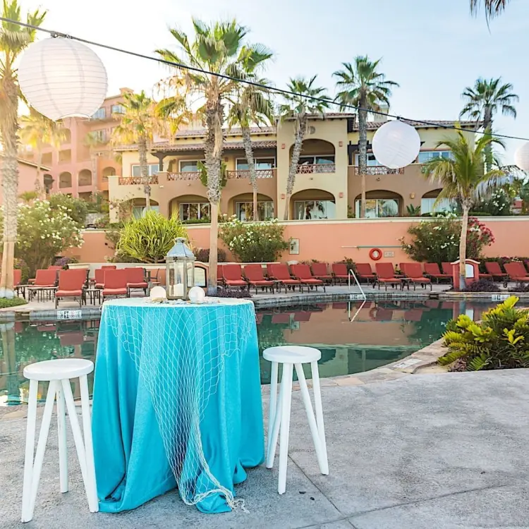 Cocktail table with turquoise linen and paper lanterns by the pool at Hacienda del Mar, Cabo San Lucas