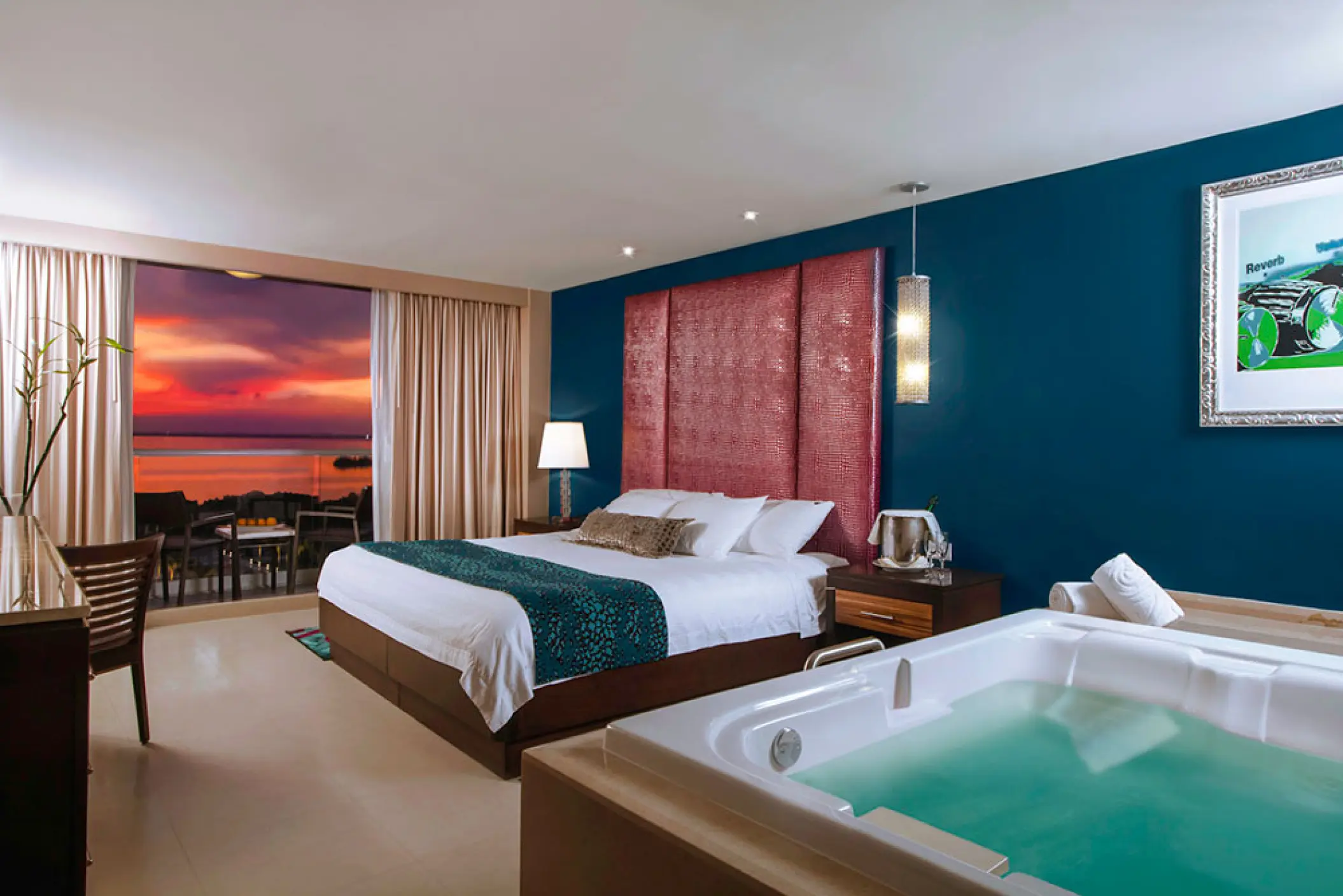 Deluxe suite with indoor hydro spa tub and sunset balcony view at Hard Rock Cancun, Cancun