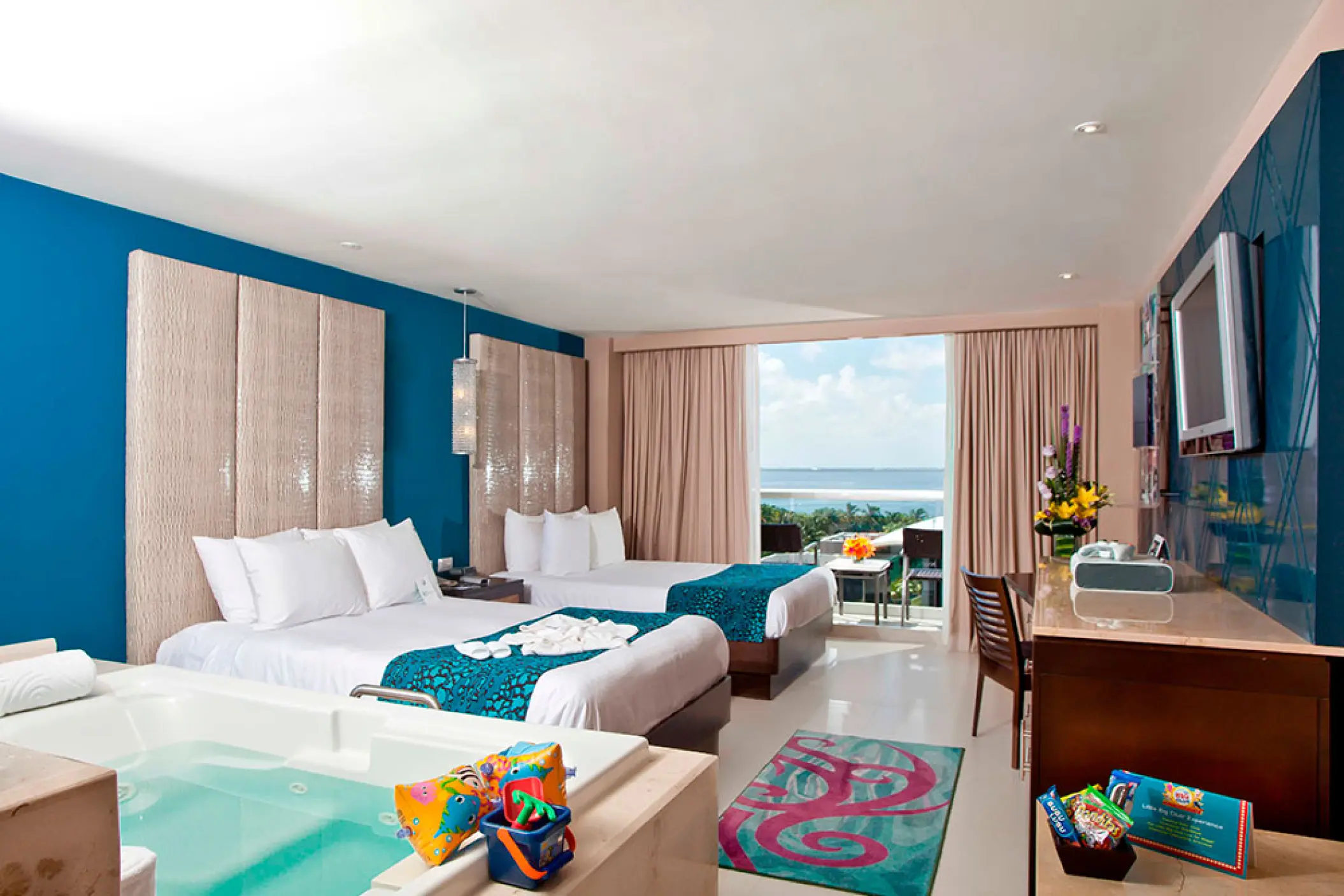 Deluxe suite with double beds, whirlpool tub, and ocean view balcony at Hard Rock Cancun