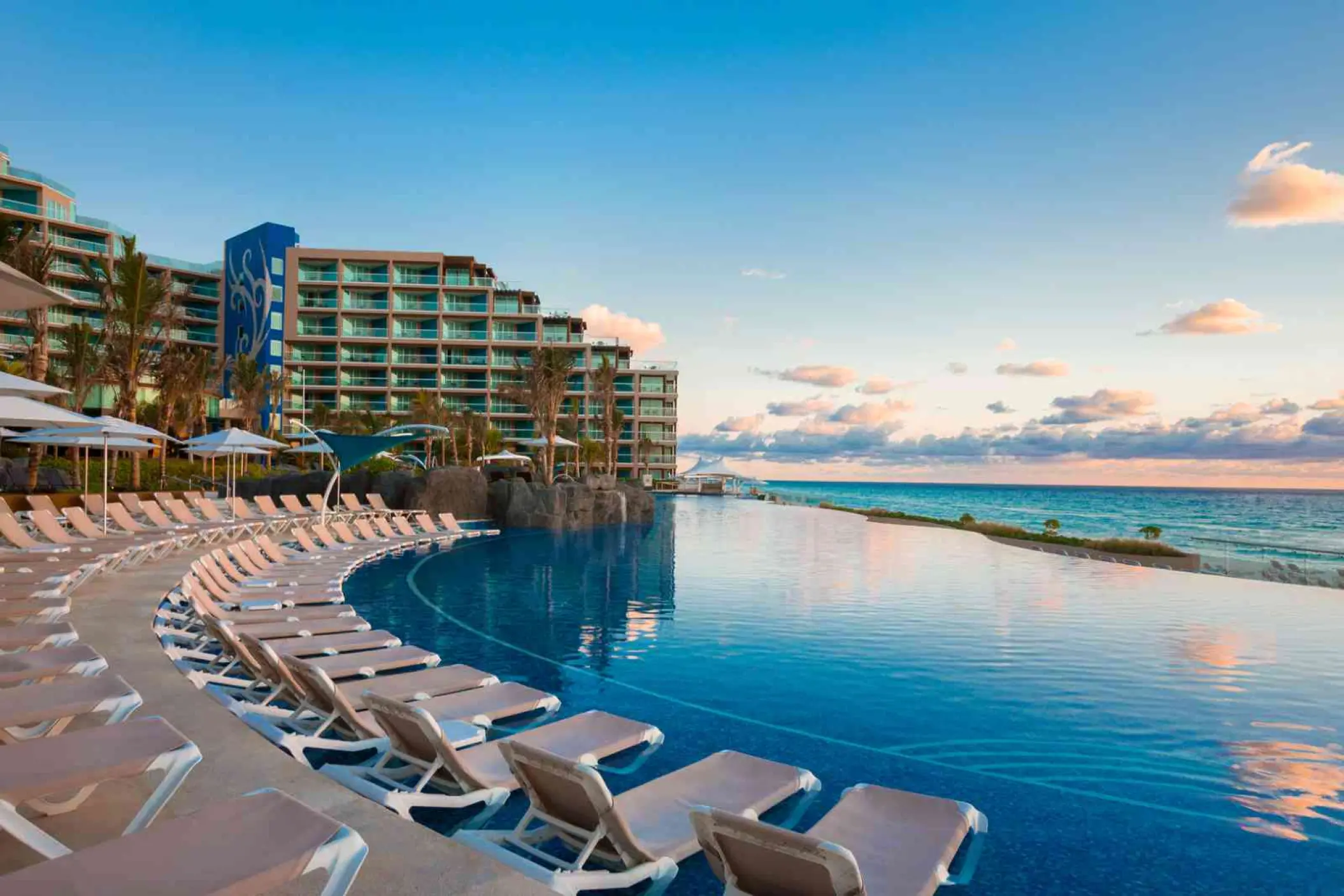 Hard Rock Cancun infinity pool with rows of lounge chairs overlooking the Caribbean Sea, Cancun