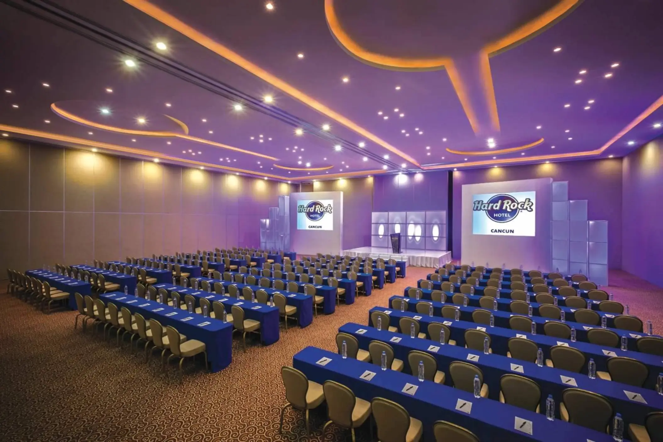 Indoor meeting room with purple lighting and blue linens at Hard Rock Cancun, Cancun