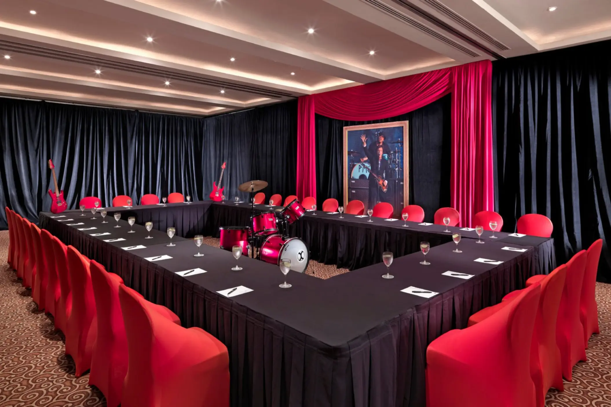 U-shaped banquet table with red chairs and music memorabilia at Hard Rock Cancun, Cancun