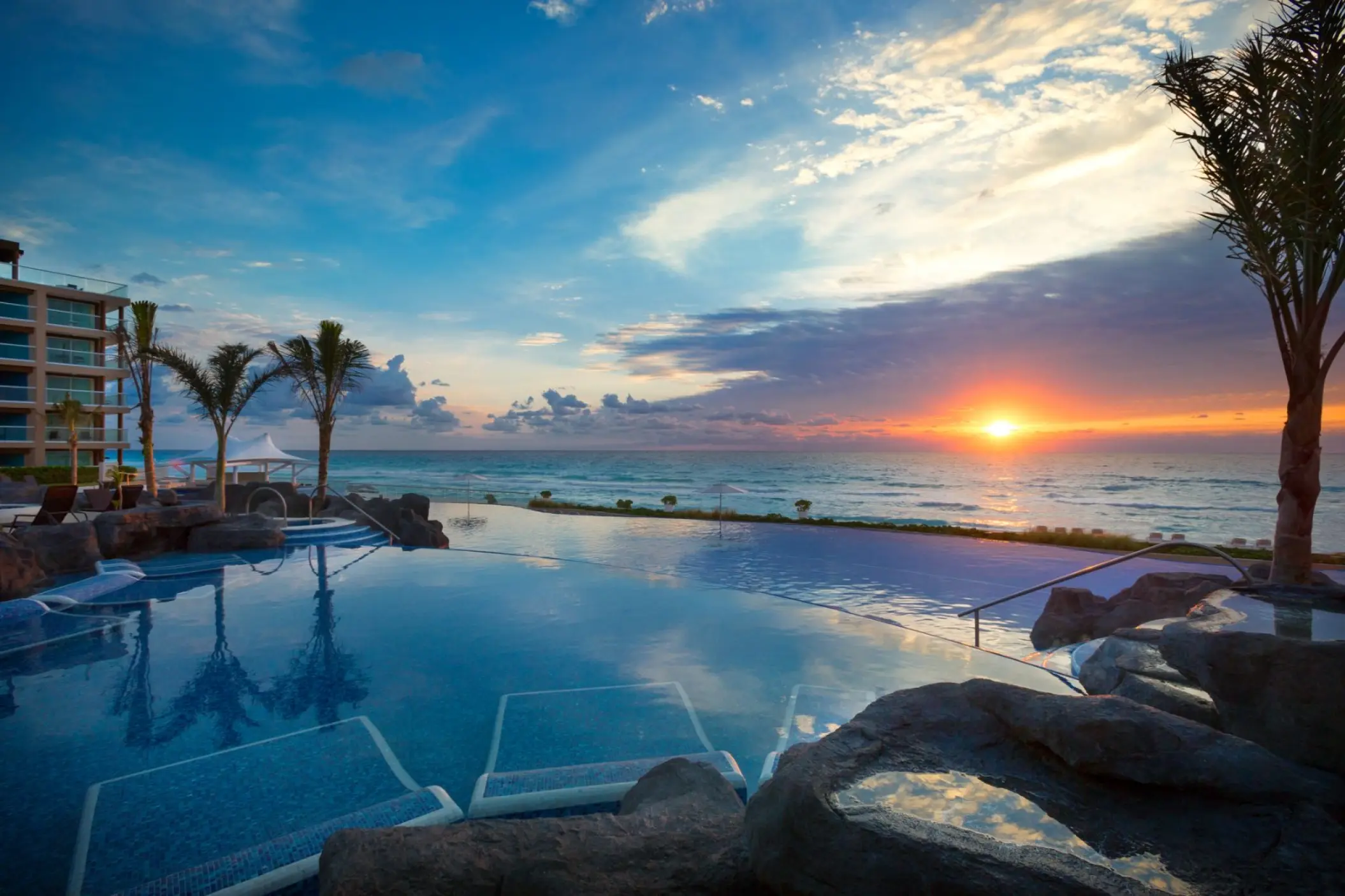 Hard Rock Cancun infinity pool with submerged loungers at sunset, Cancun