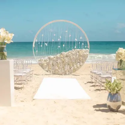 Beachfront wedding ceremony with circular floral arch at Hard Rock Cancun, Cancun