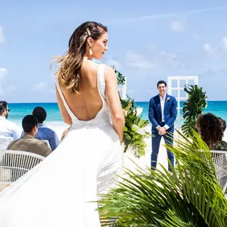 Bride walking down the aisle for a beach ceremony at Hard Rock Cancun