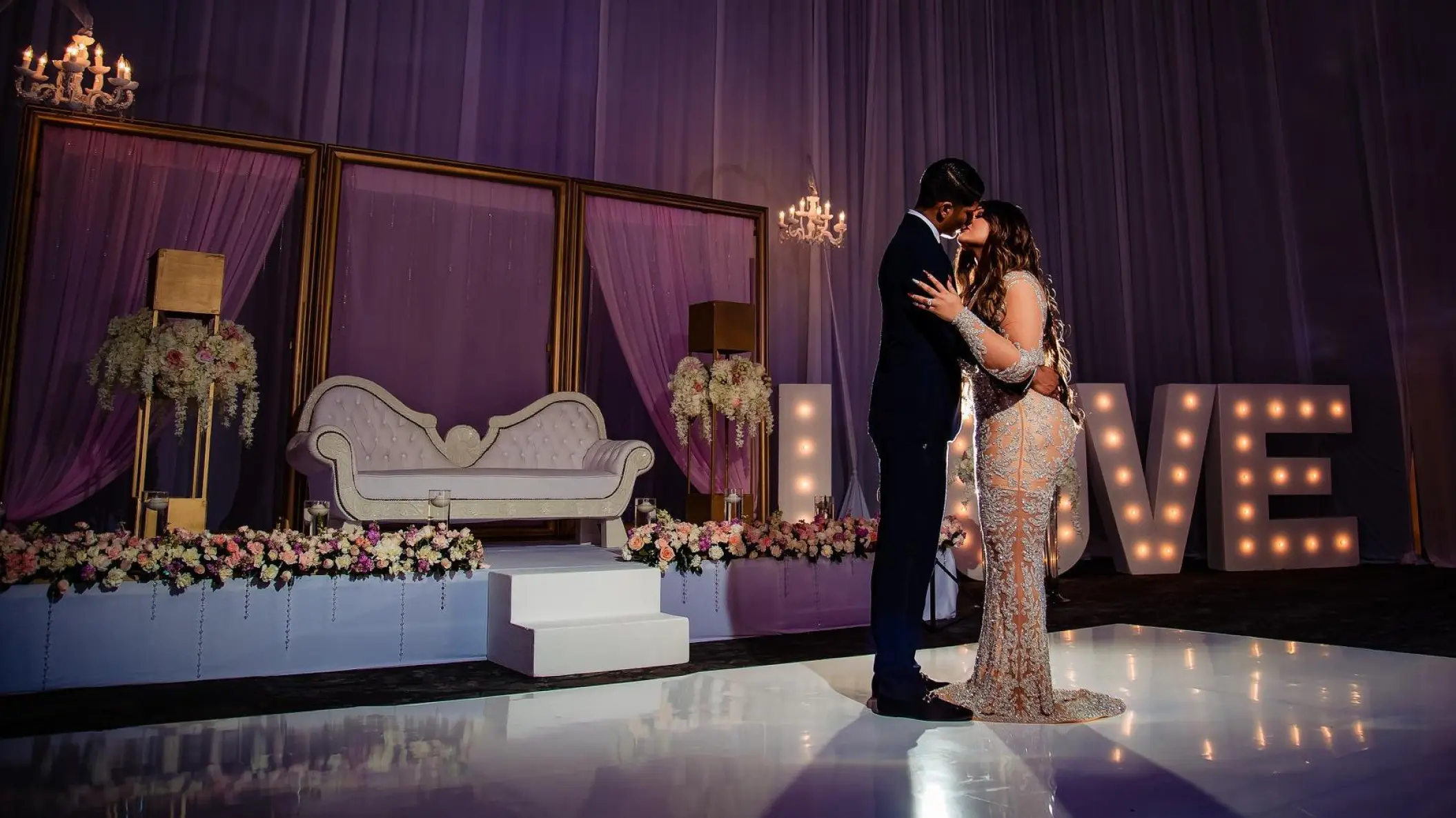 Couple kissing during an indoor wedding reception at Hard Rock Cancun, Cancun
