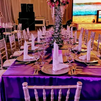 Indoor wedding reception with purple linens and silver chairs at Hard Rock Cancun, Cancun