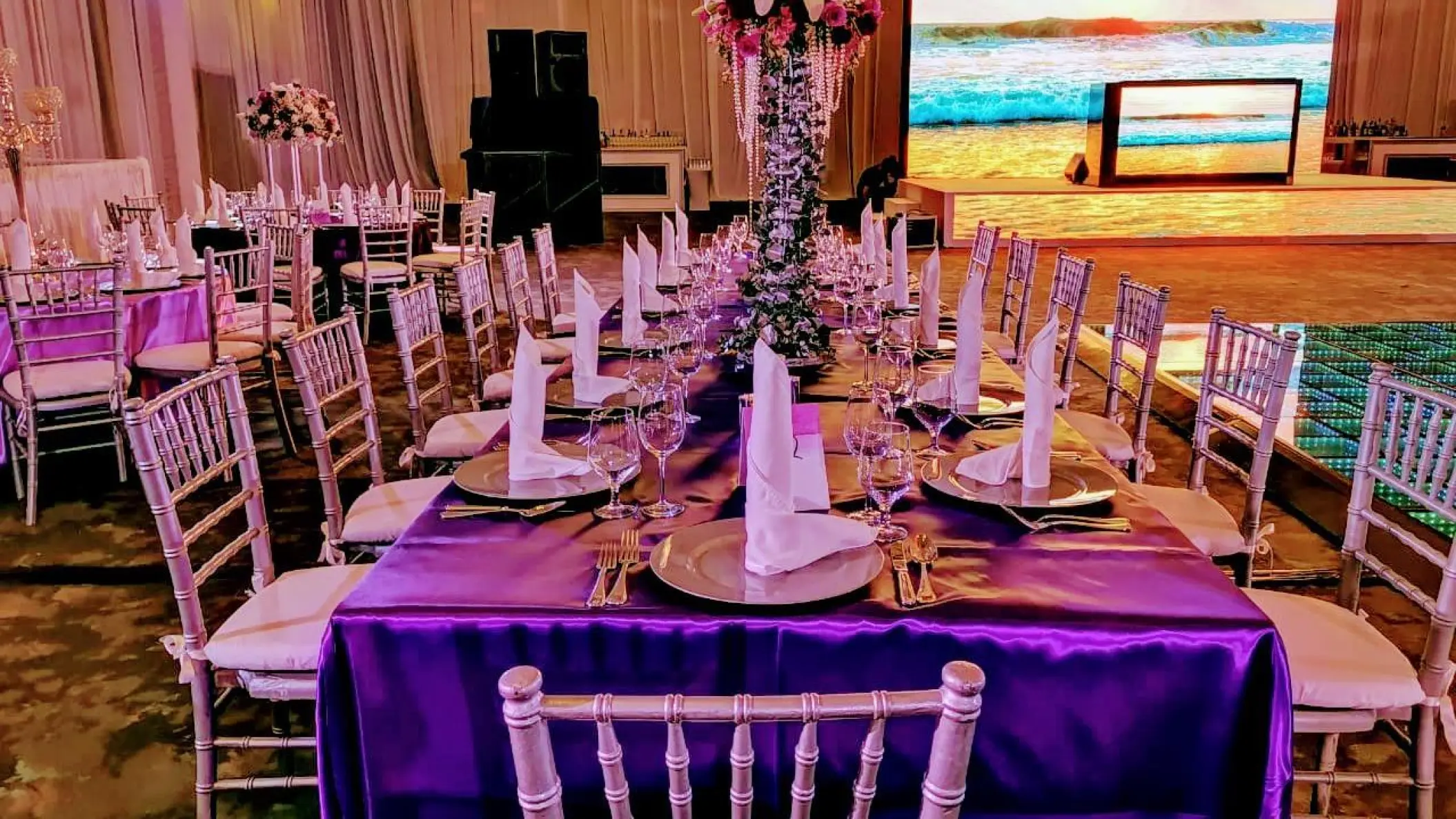 Indoor wedding reception with purple linens and silver chairs at Hard Rock Cancun, Cancun
