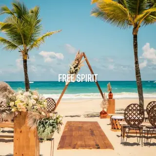 Free Spirit boho beach ceremony with wooden triangular arch at Hard Rock Cancun, Cancun