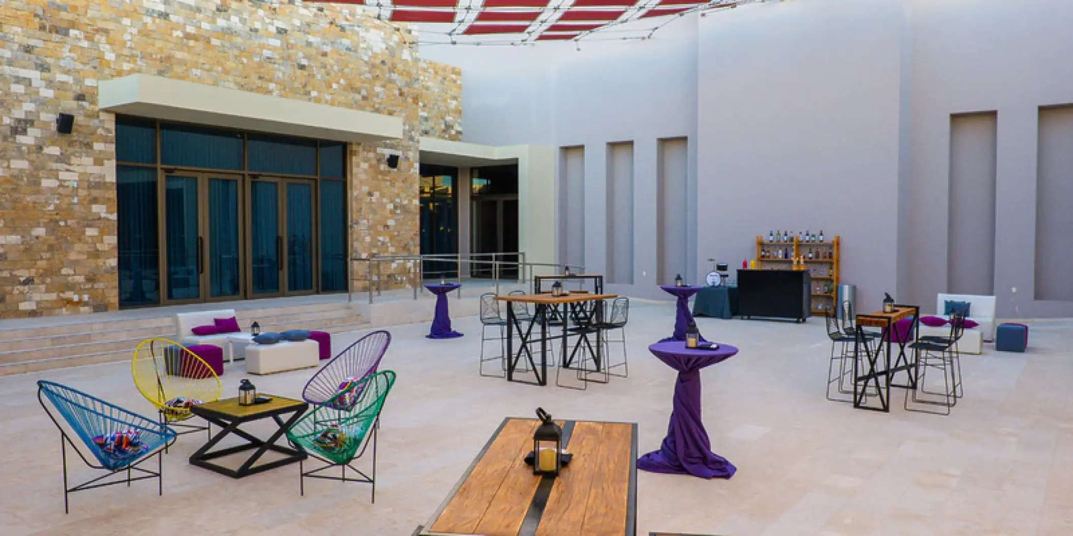 Beat Patio lounge and cocktail setup with colorful Acapulco chairs at Hard Rock Los Cabos, Cabo San Lucas