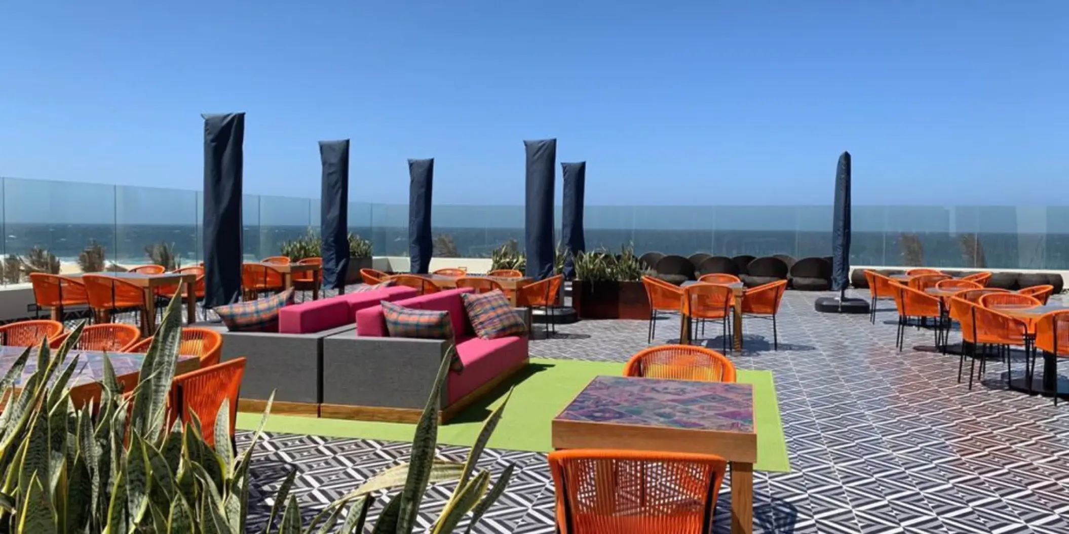 Los Gallos Terrace wedding venue with orange chairs and ocean views at Hard Rock Los Cabos, Cabo San Lucas