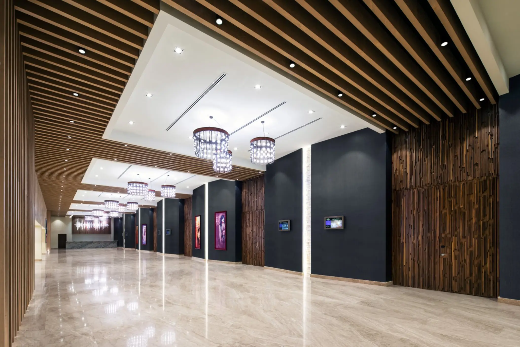 Modern indoor events lobby with wood-slat ceilings and crystal chandeliers at Hard Rock Los Cabos, Cabo San Lucas