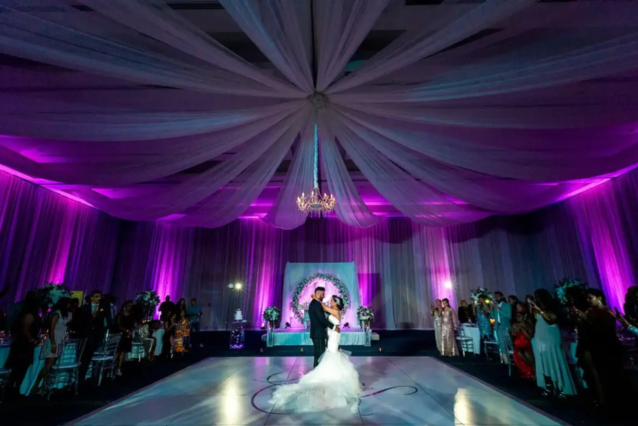 First dance in a ballroom with purple lighting and white ceiling drapes at Hard Rock Hotel Punta Cana