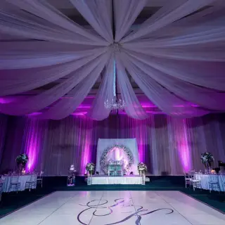 Indoor wedding reception ballroom with purple lighting and white draped ceiling at Hard Rock Hotel Punta Cana