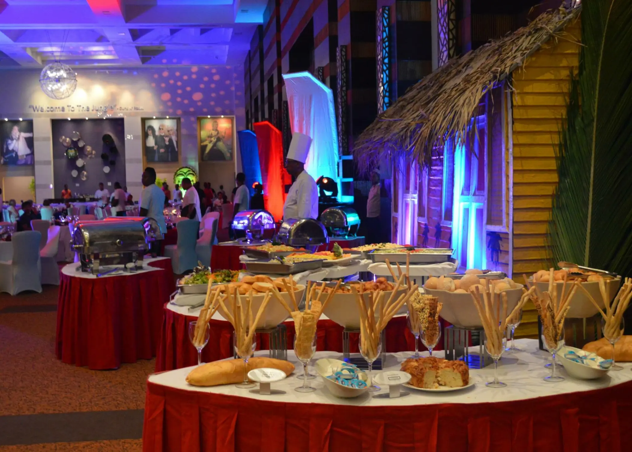 Buffet dinner setup with breads and warm lighting in a ballroom at Hard Rock Punta Cana