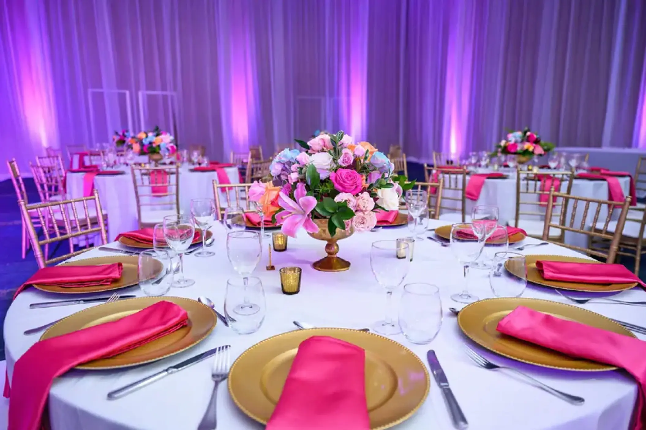 Indoor wedding reception with pink floral centerpieces at Hard Rock Punta Cana