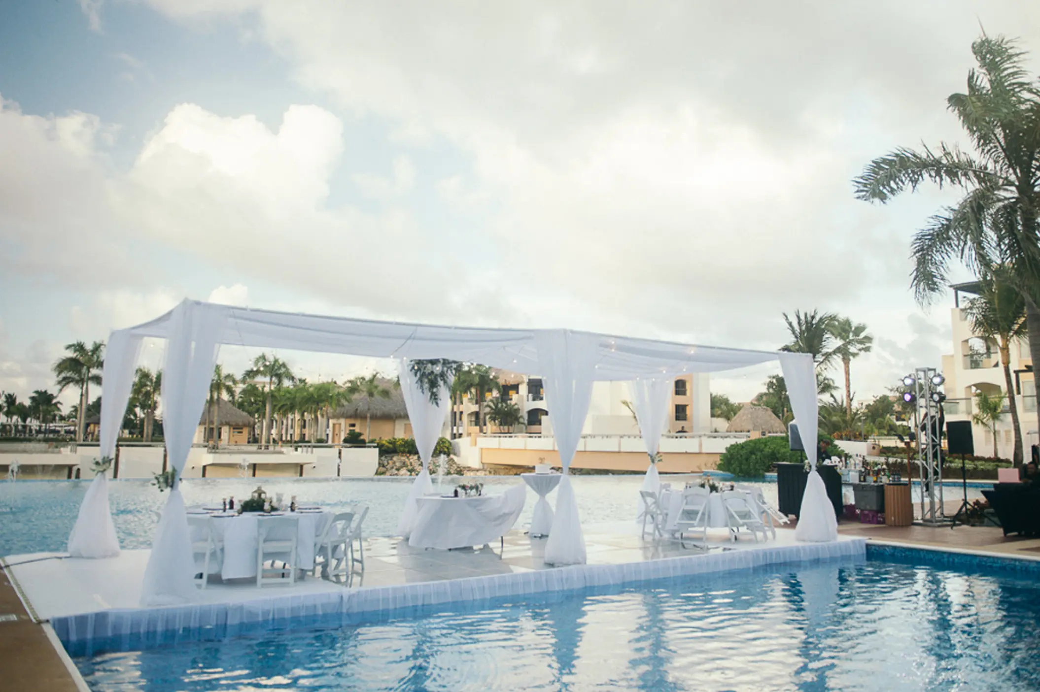 Outdoor wedding reception setup on a pool platform at Hard Rock Punta Cana