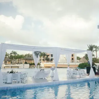 Outdoor wedding reception setup on a pool platform at Hard Rock Punta Cana