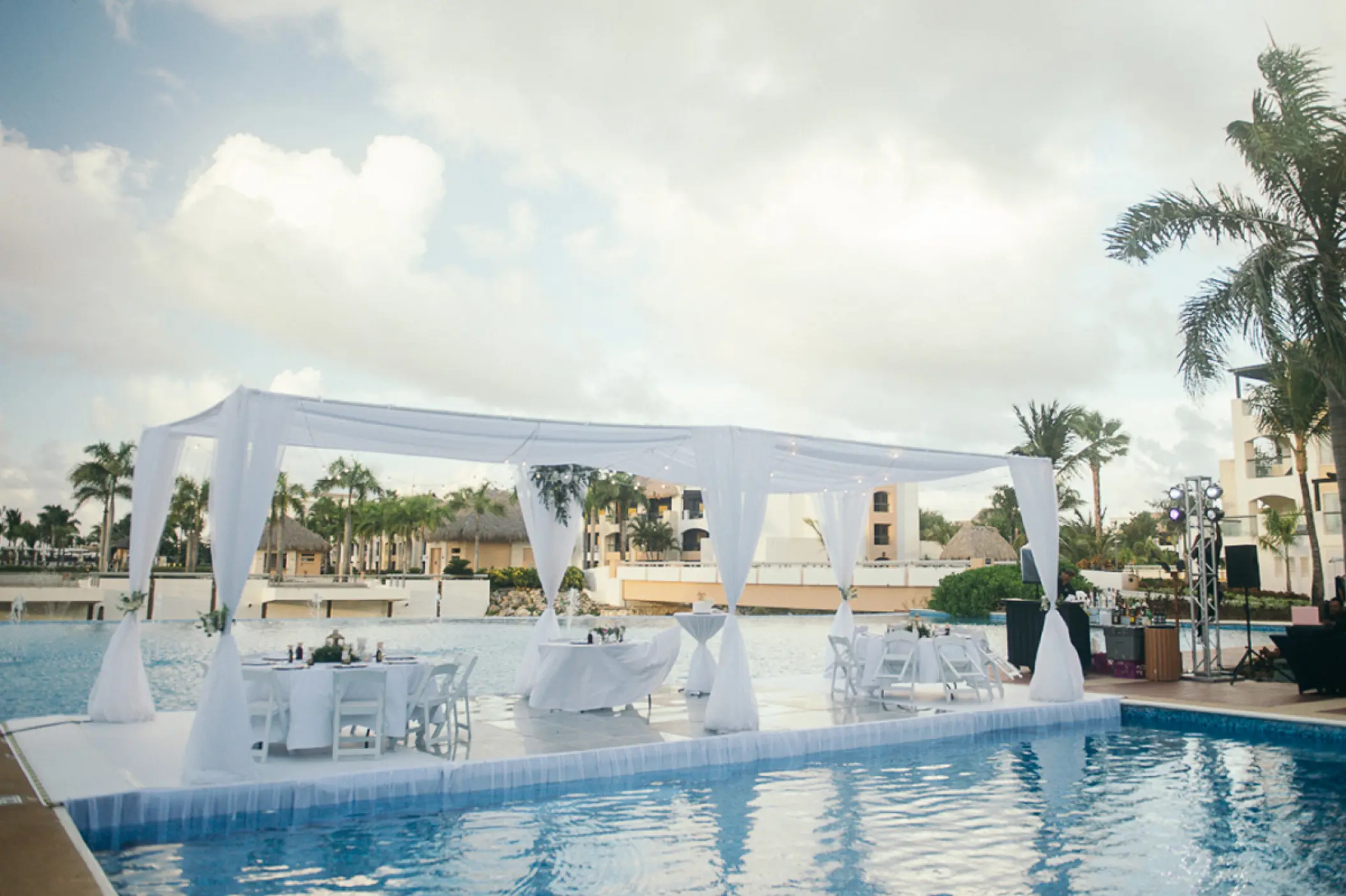 Outdoor wedding reception setup on a pool platform at Hard Rock Punta Cana