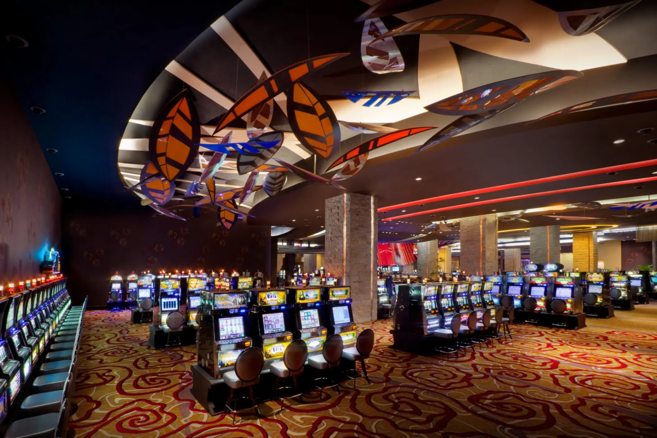 Slot machines and modern overhead decor in the casino at Hard Rock Punta Cana