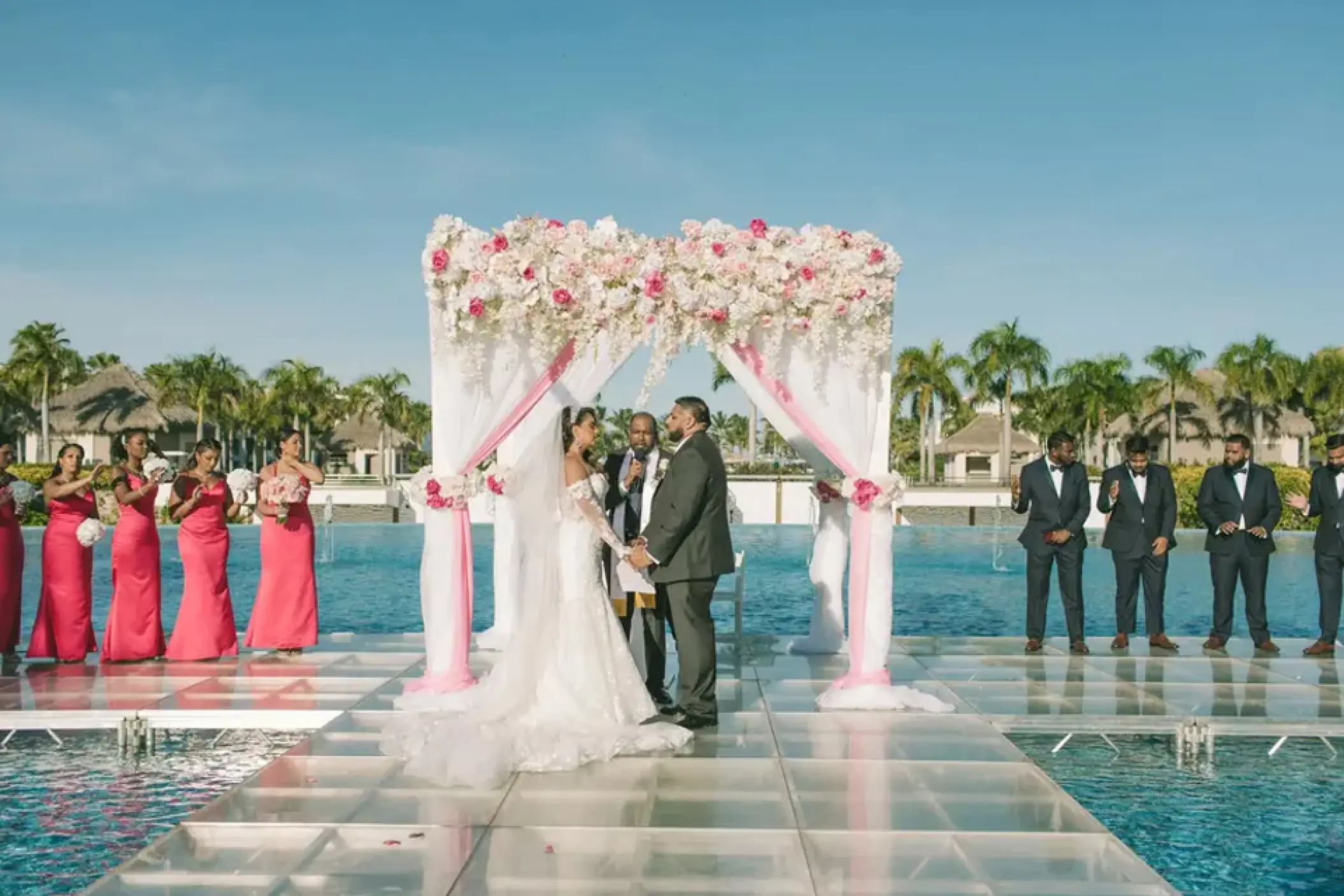 Glass aisle wedding ceremony over a pool at Hard Rock Punta Cana