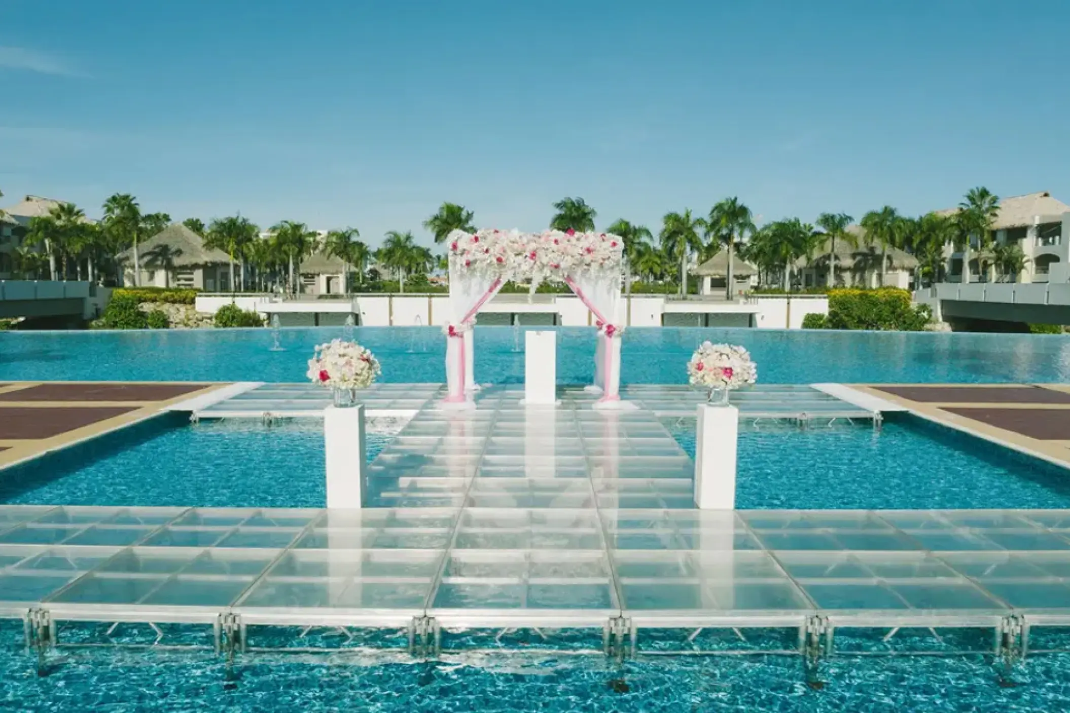 Outdoor wedding ceremony setup on a glass platform over a canal at Hard Rock Punta Cana