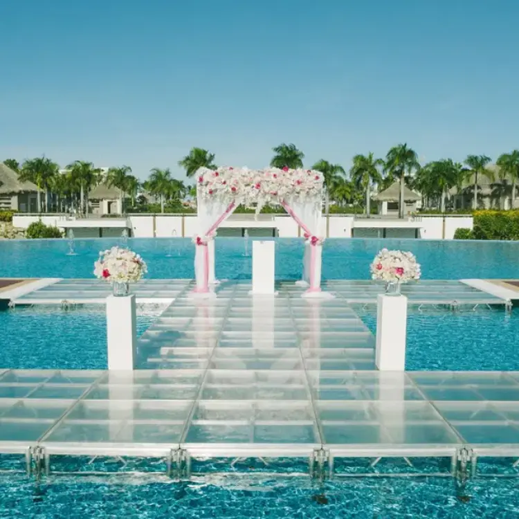 Outdoor wedding ceremony setup on a glass platform over a canal at Hard Rock Punta Cana