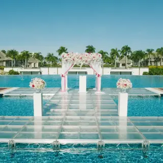 Outdoor wedding ceremony setup on a glass platform over a canal at Hard Rock Punta Cana