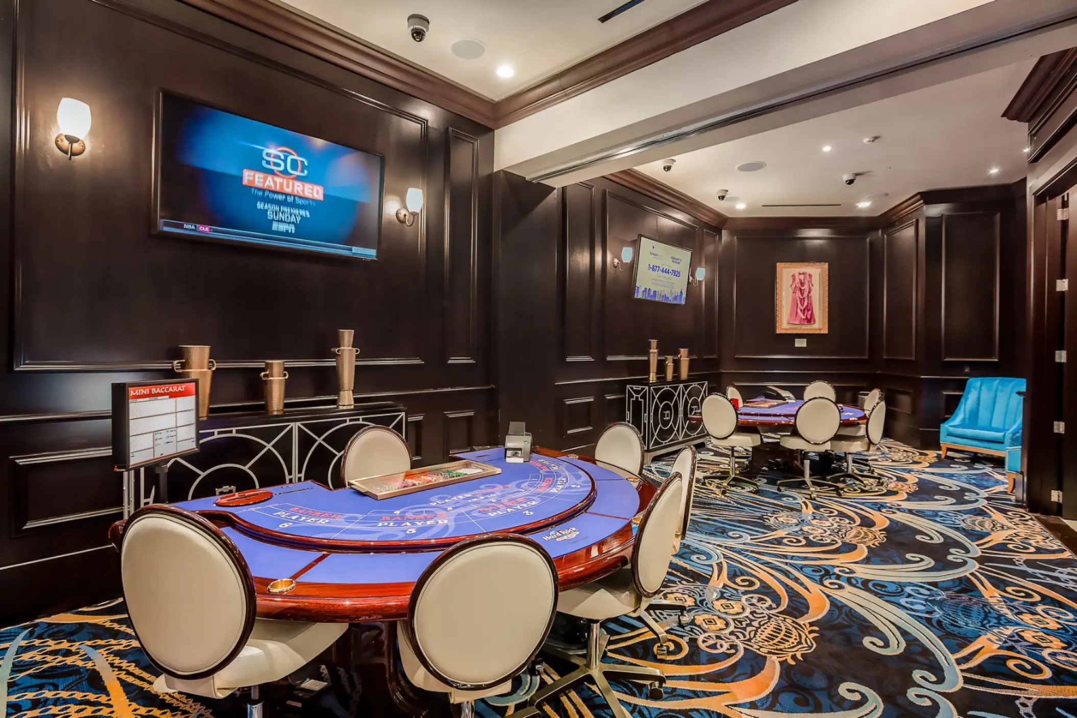 Casino lounge with card tables and dark wood paneling at Hard Rock Punta Cana