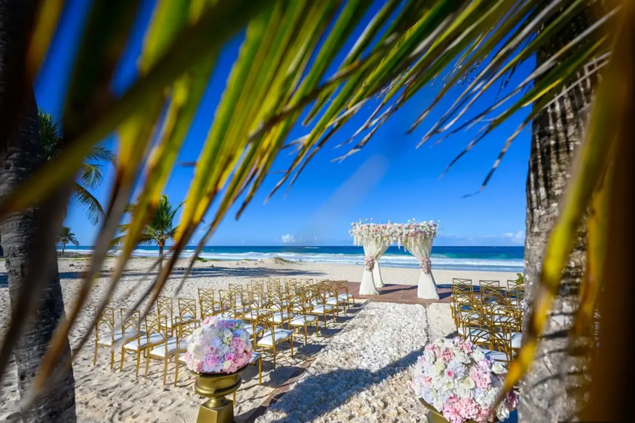 Beachfront wedding ceremony with a floral gazebo at Hard Rock Hotel Punta Cana, Punta Cana