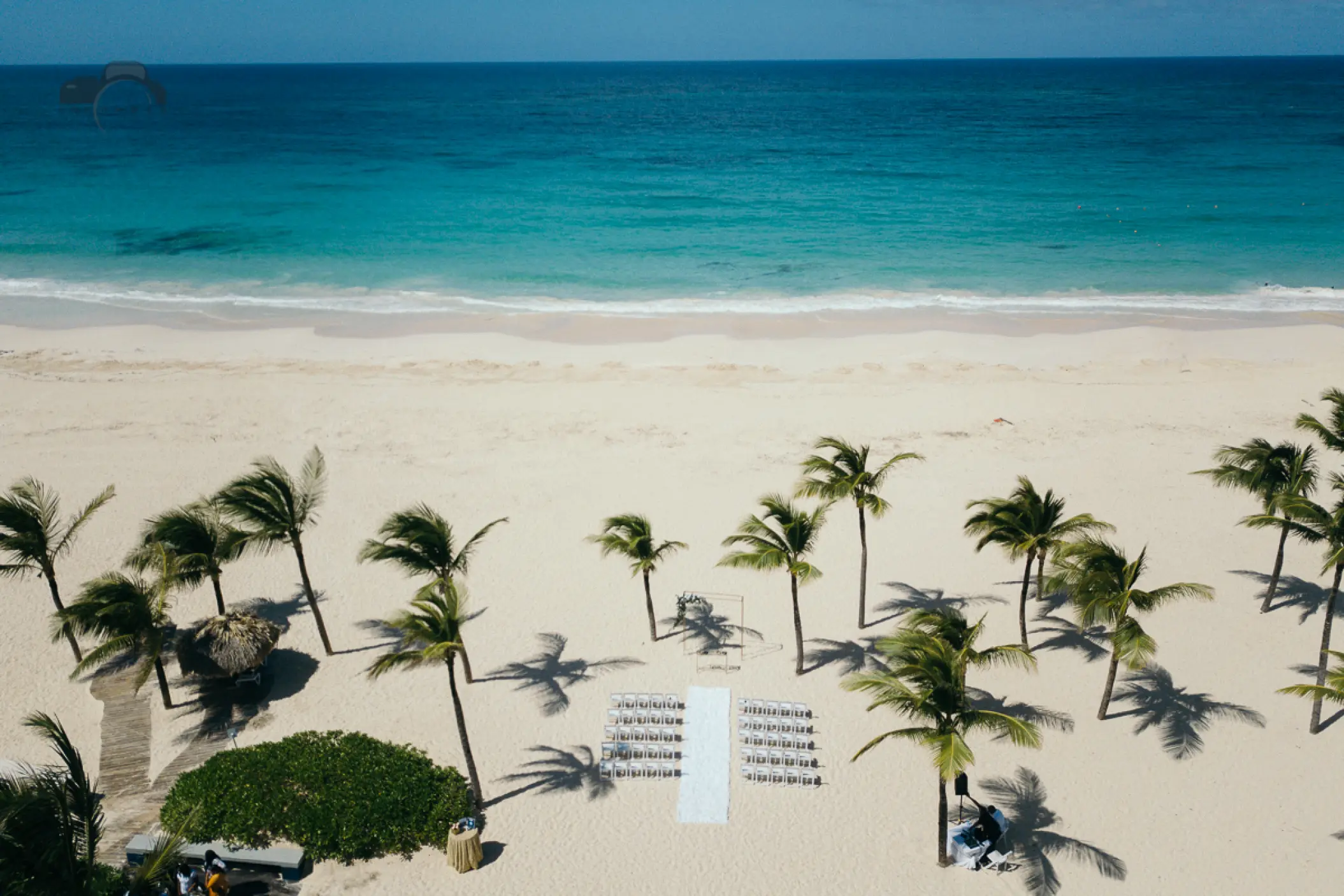 Aerial view of a beach ceremony setup among palm trees at Hard Rock Punta Cana