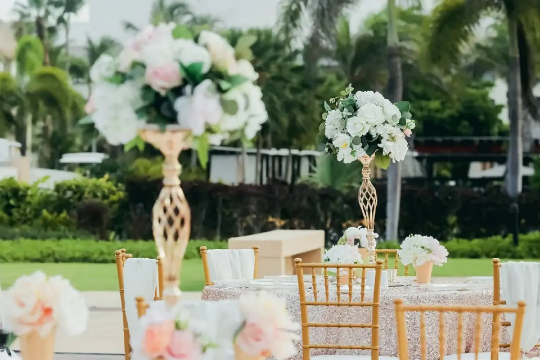 Outdoor wedding reception setup with gold chairs and floral centerpieces at Hard Rock Punta Cana