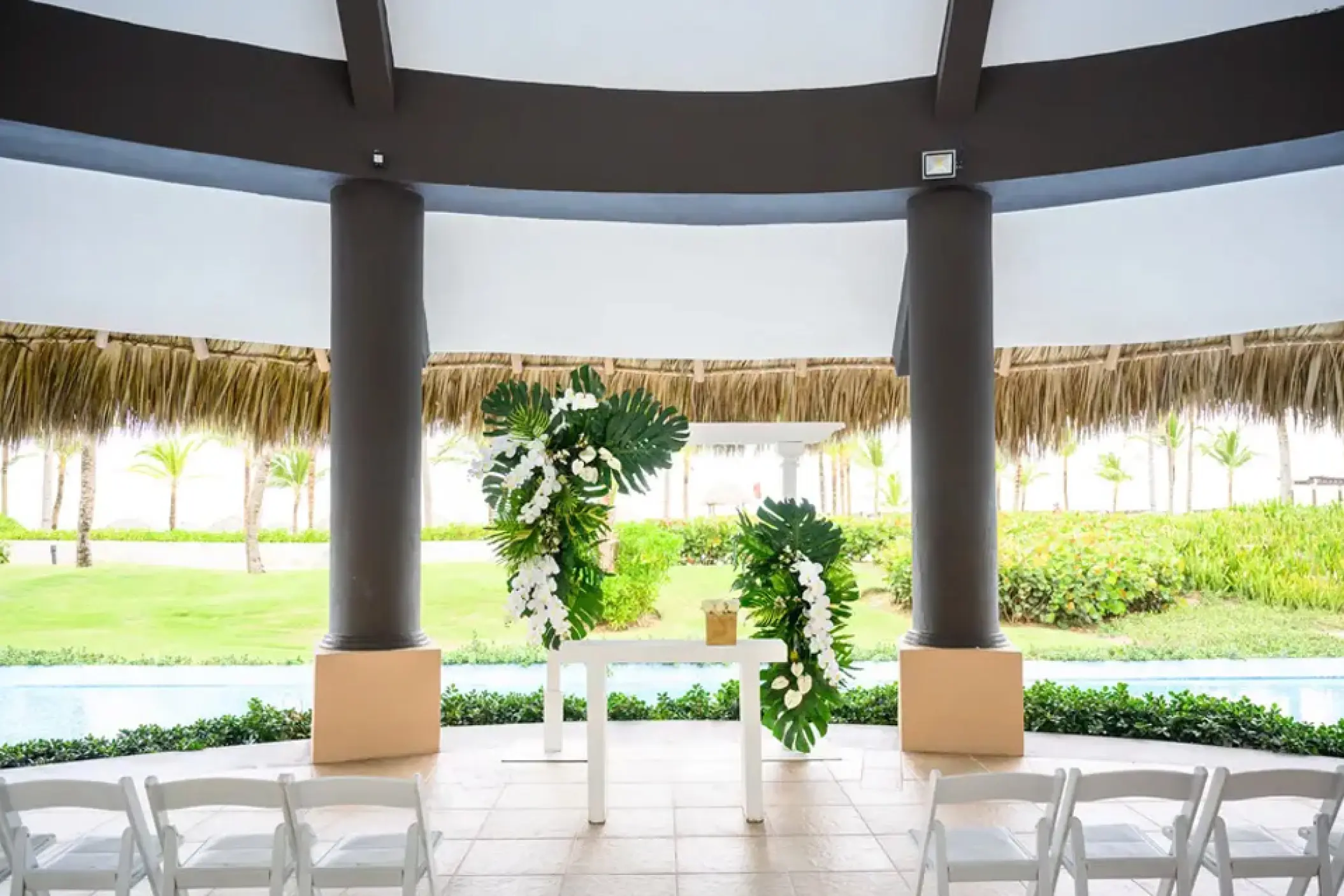Wedding ceremony setup with tropical floral pillars at Hard Rock Punta Cana