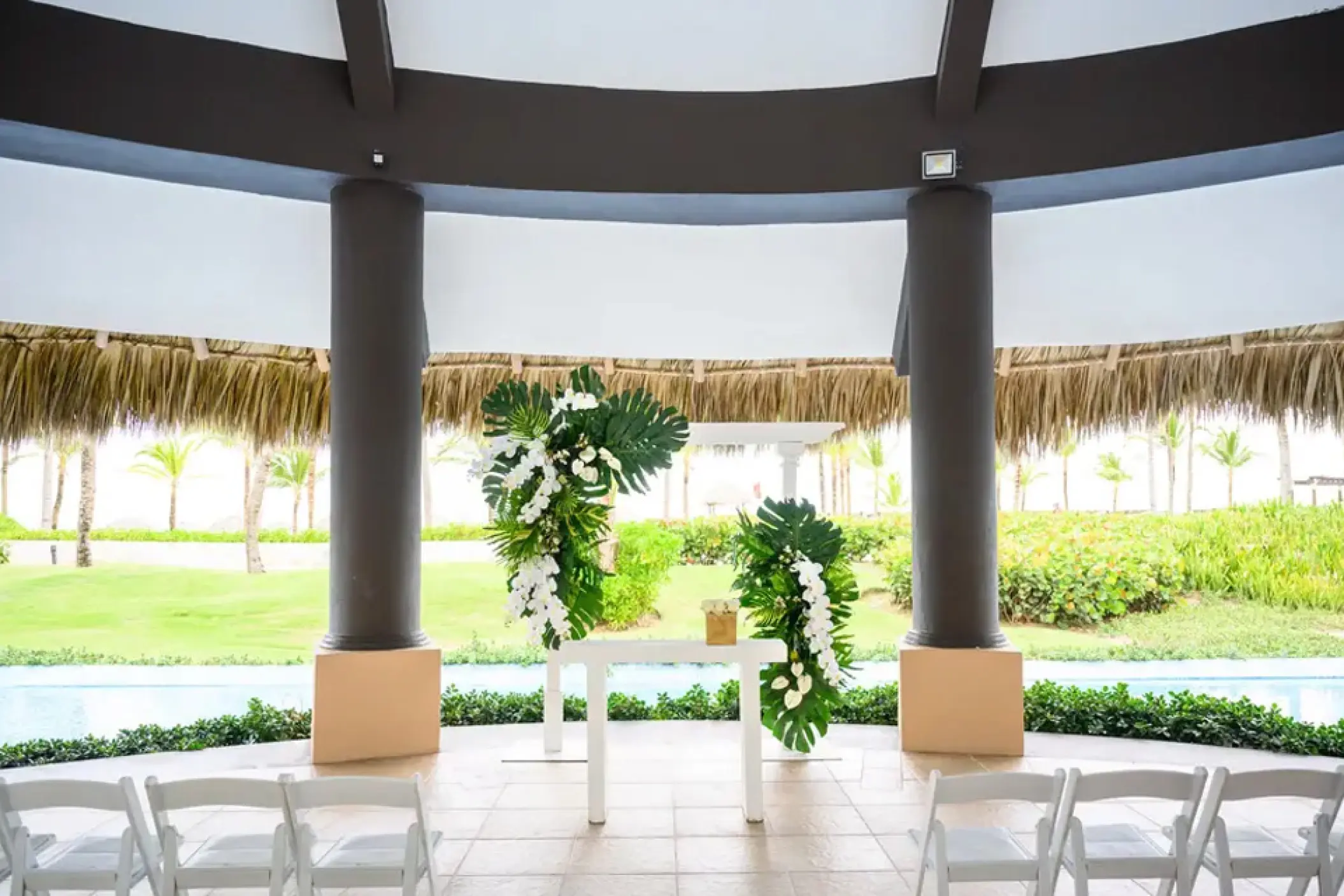 Wedding ceremony setup with tropical floral pillars at Hard Rock Punta Cana