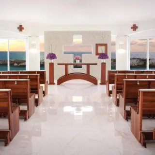 Ocean view wedding chapel with wooden pews at Hard Rock Riviera Maya