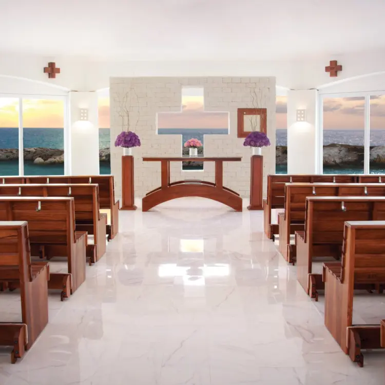 Ocean view wedding chapel with wooden pews at Hard Rock Riviera Maya