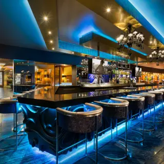 Heaven Bar with neon blue lighting and modern chandeliers at Hard Rock Riviera Maya