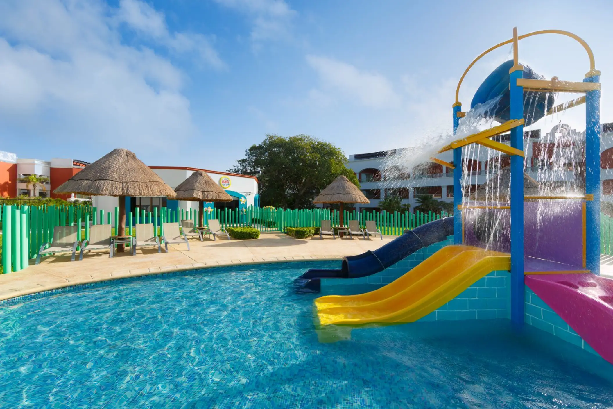 Colorful water slides and kids splash pool at Hard Rock Riviera Maya