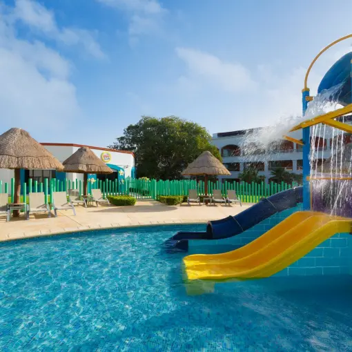 Colorful water slides and kids splash pool at Hard Rock Riviera Maya