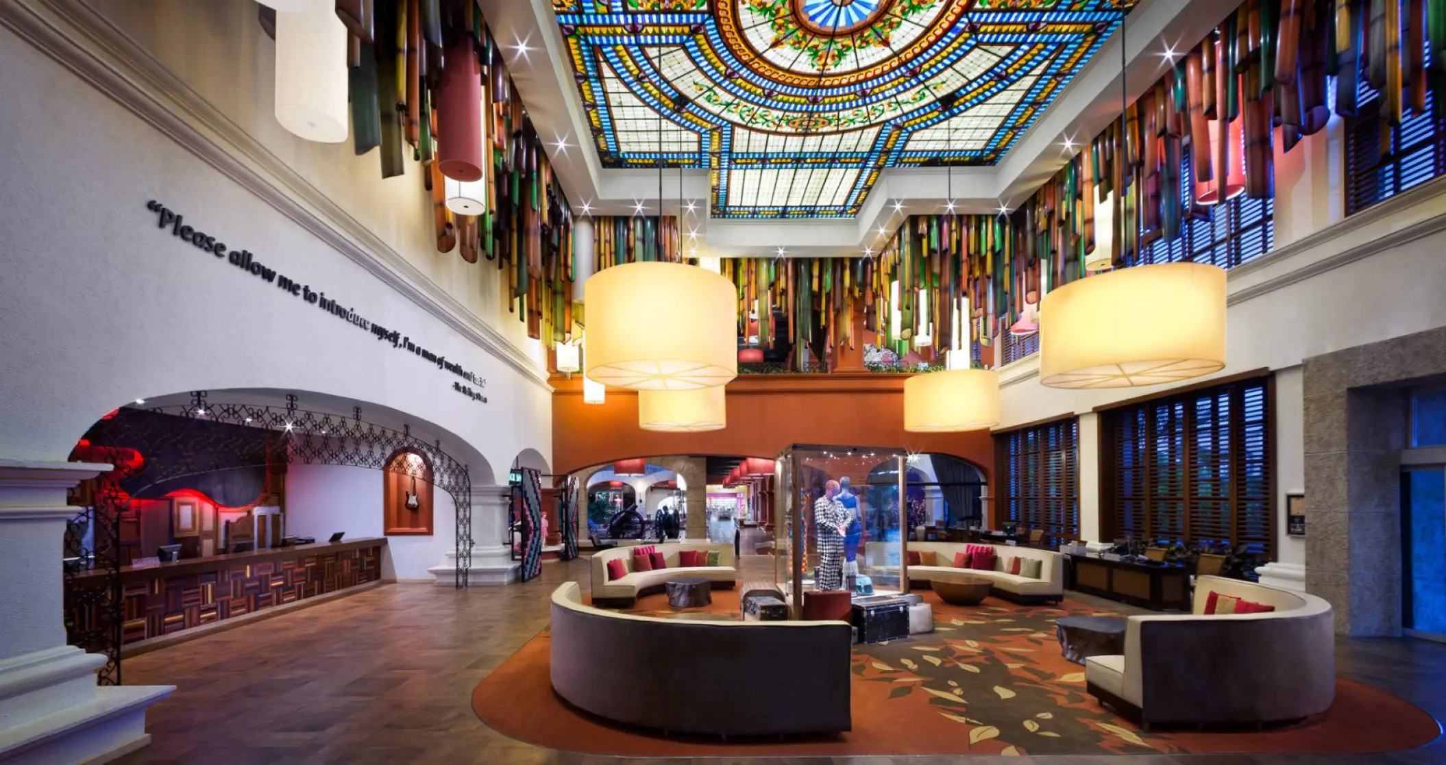 Hard Rock Hotel Riviera Maya lobby featuring a colorful stained-glass ceiling and modern lounge seating, Riviera Maya